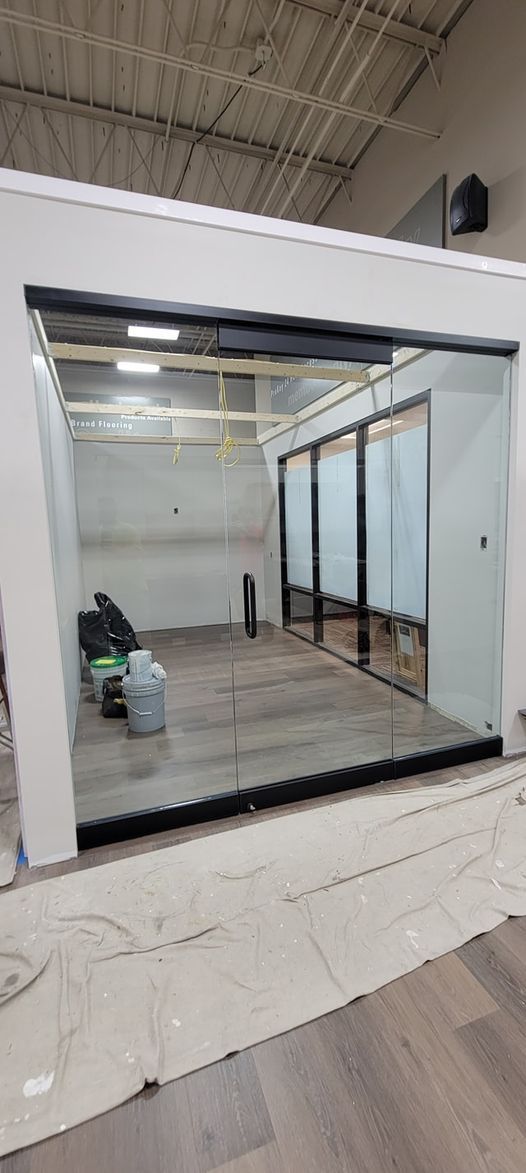 A room with a lot of windows and a mirror on the wall.