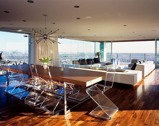 A living room with a table and chairs and a view of the city.
