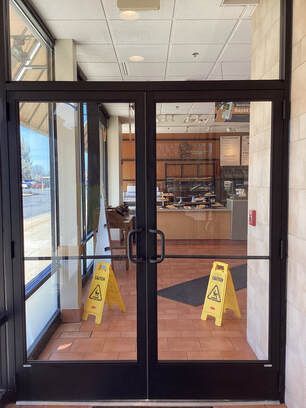 There are two yellow caution signs in front of the door.