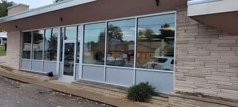 A large building with a lot of windows and a door.