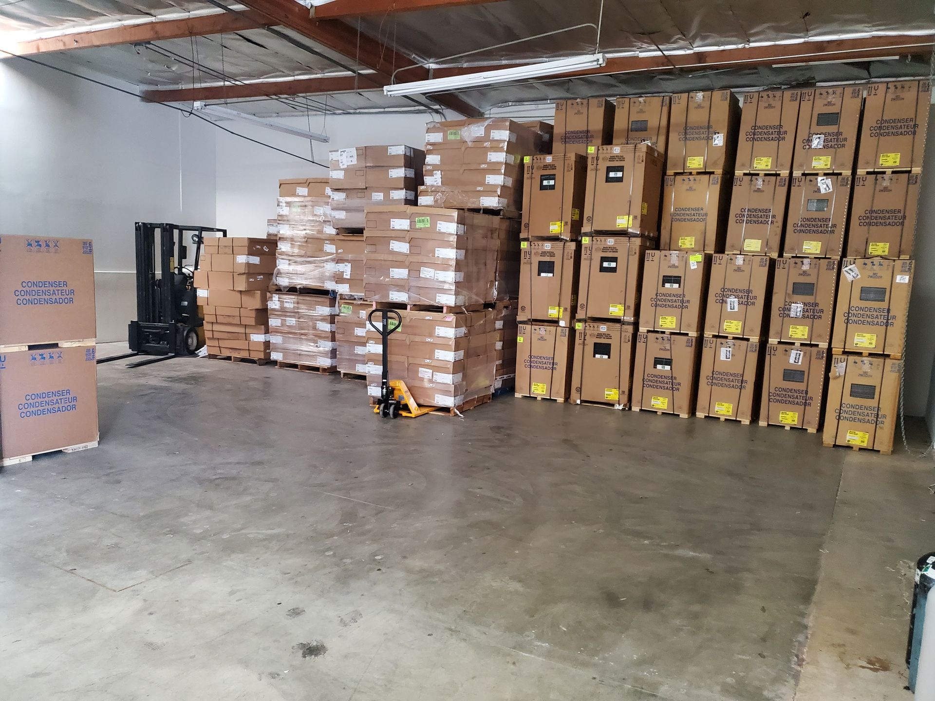 A warehouse filled with lots of boxes and a forklift