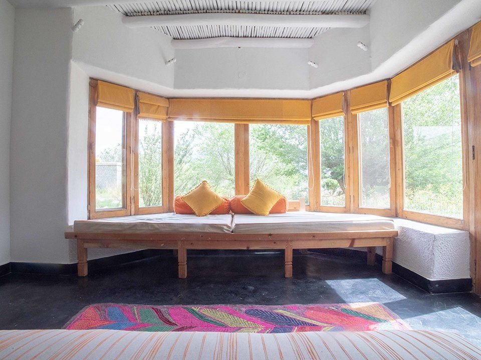 A living room with a couch and lots of windows