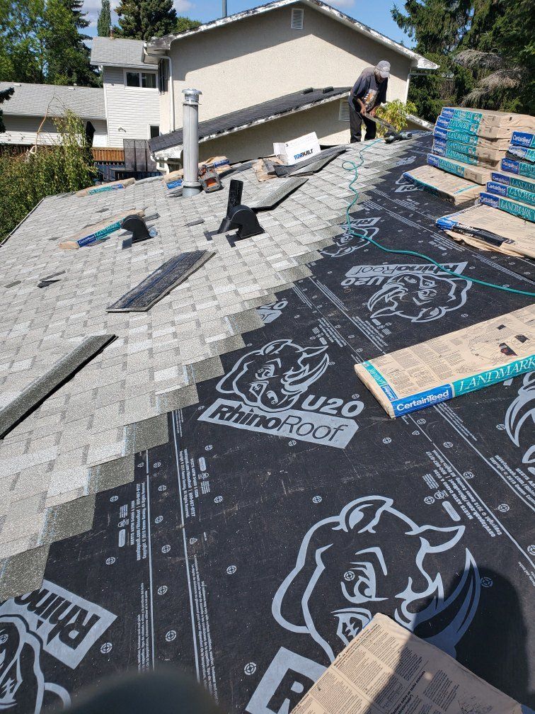 A man is working on the roof of a house.