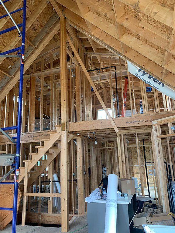 A house is being built with wooden beams and stairs.