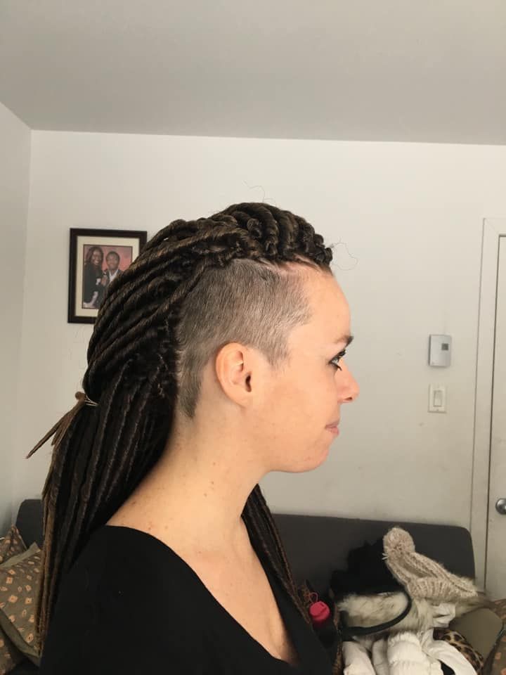 A woman with braids and a shaved head