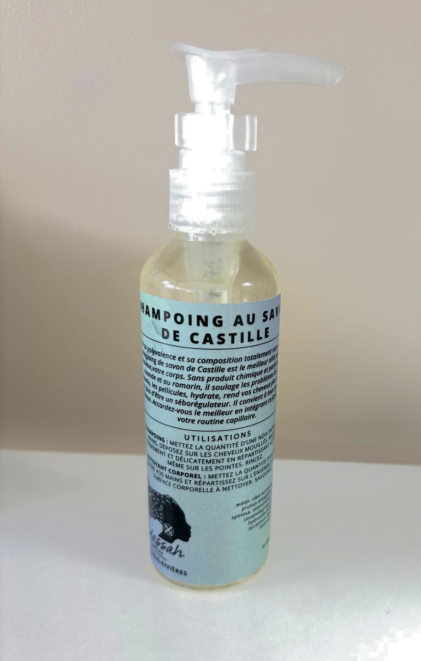 A girl with braids in her hair is wearing a pink tank top