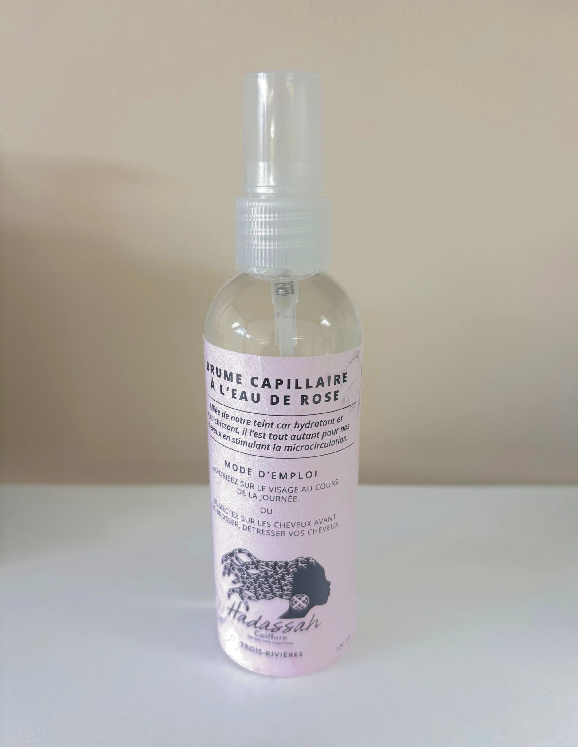 A man with dreadlocks is sitting in a chair with his back to the camera.