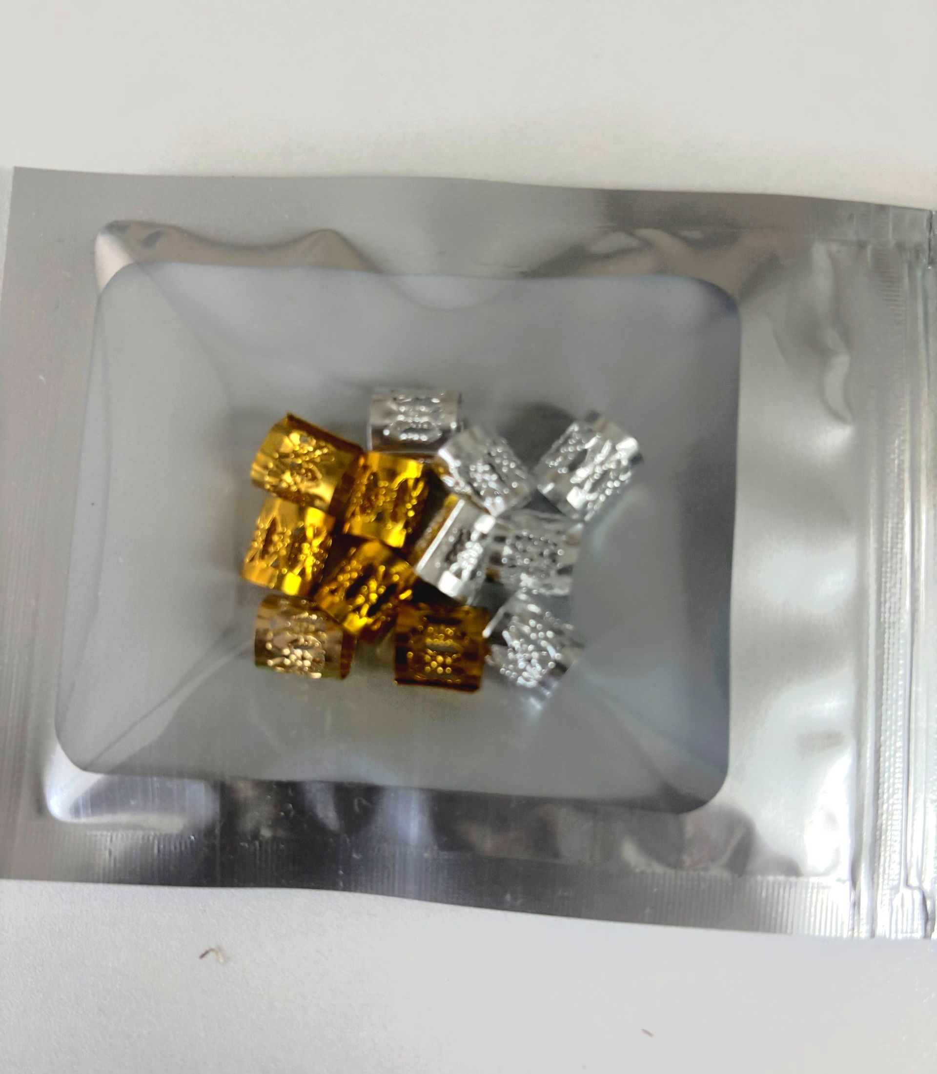 A woman with red braids is sitting in a chair in front of a mirror.