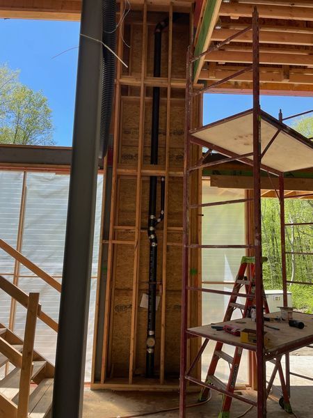 A ladder is sitting on a table in a room under construction.