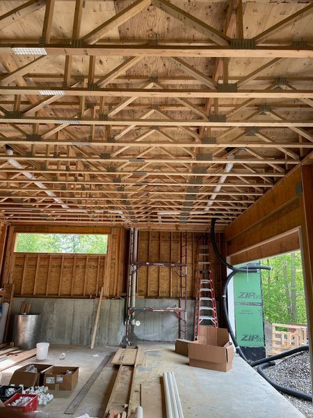 The inside of a building under construction with wooden beams