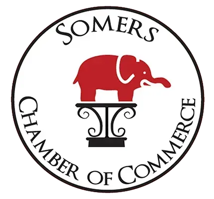 Somers Chamber of Commerce logo with a red elephant atop a decorative stand.