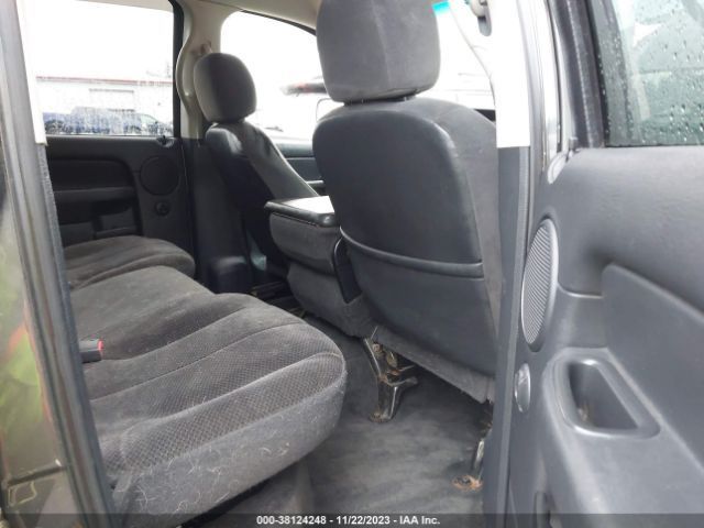 Interior of a truck with dark gray cloth seats and a center console.