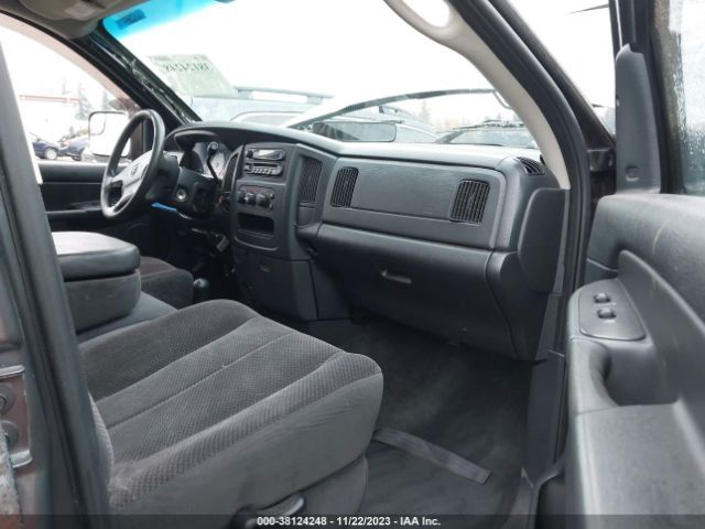 Interior view of a black Dodge Ram truck showing seats, dashboard, and steering wheel.