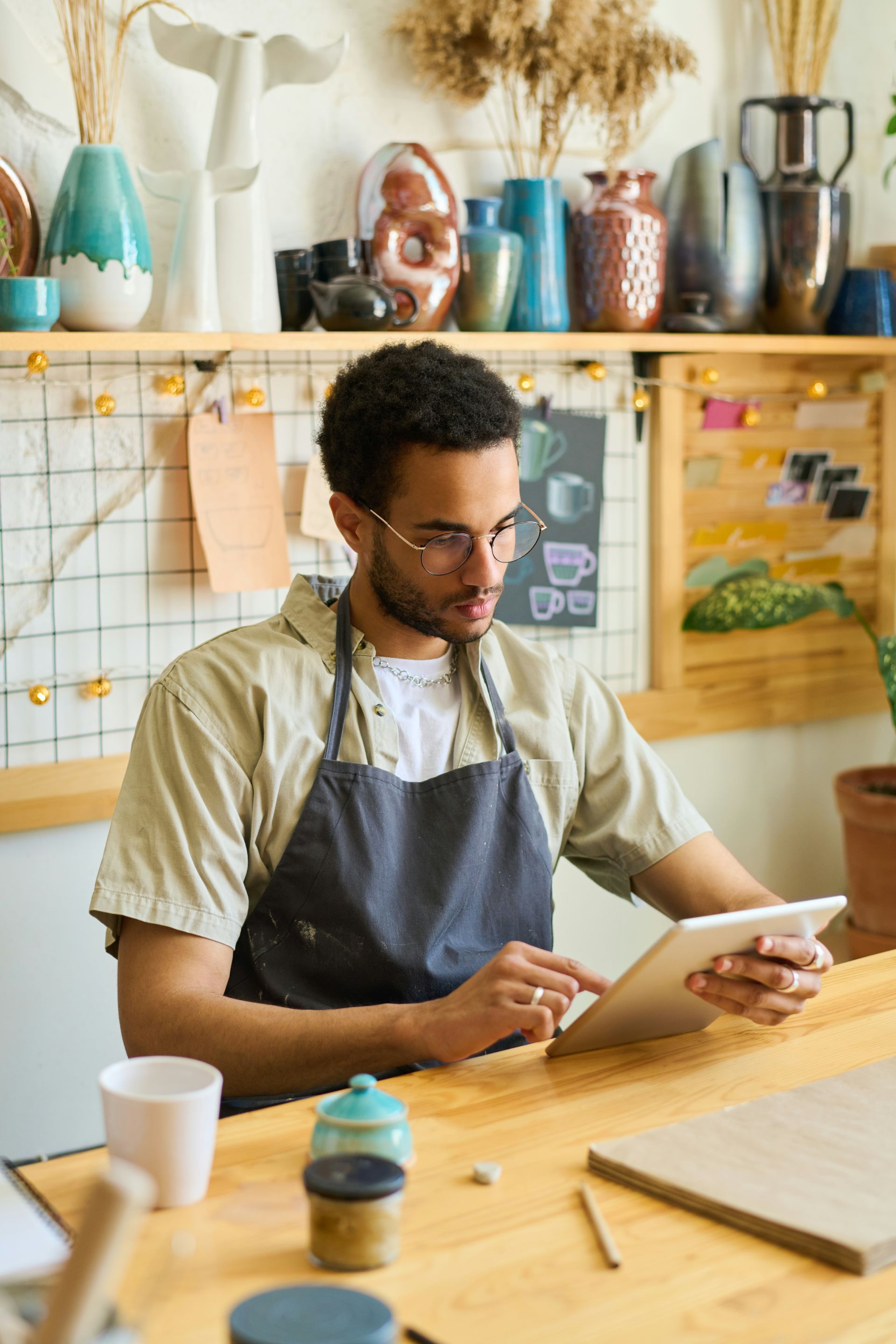 A man and a woman are sitting at a table with a laptop.