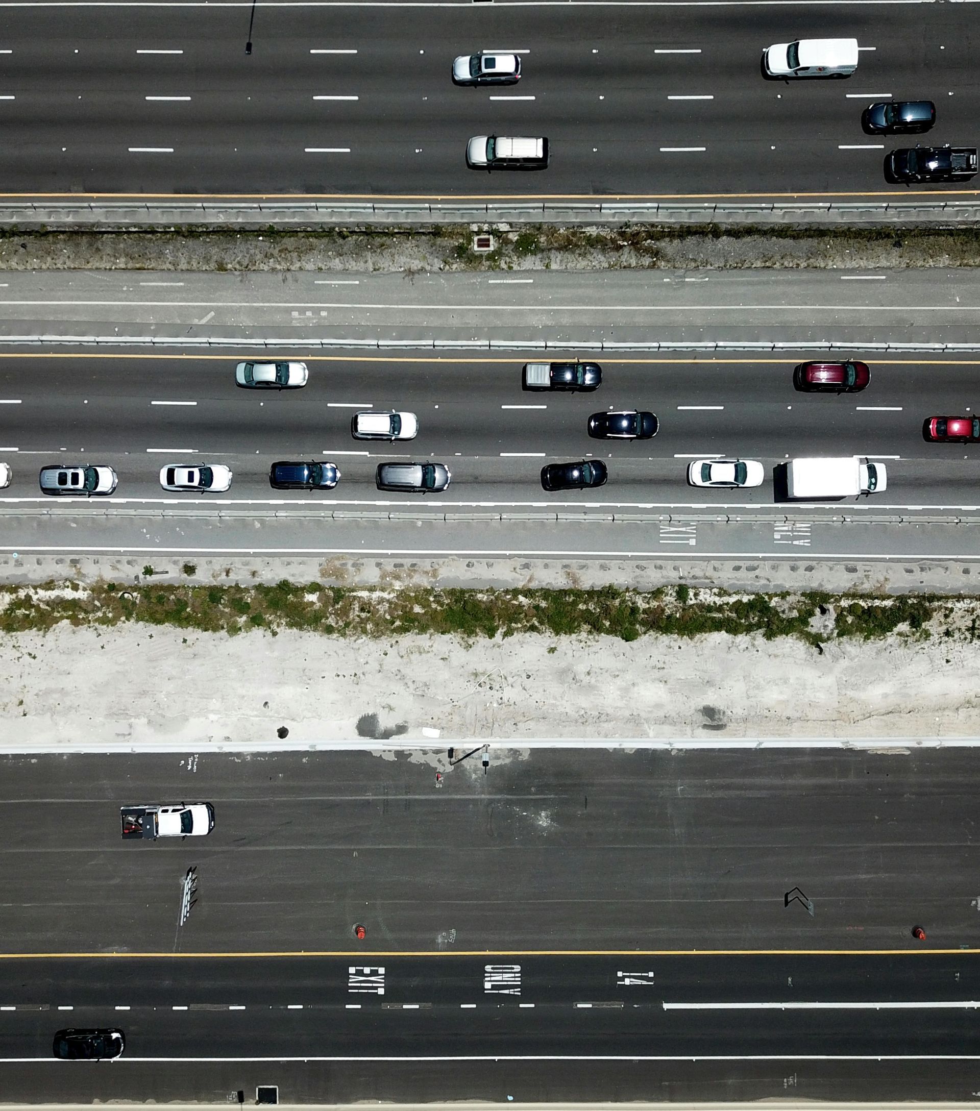 An aerial view of a highway with cars and trucks