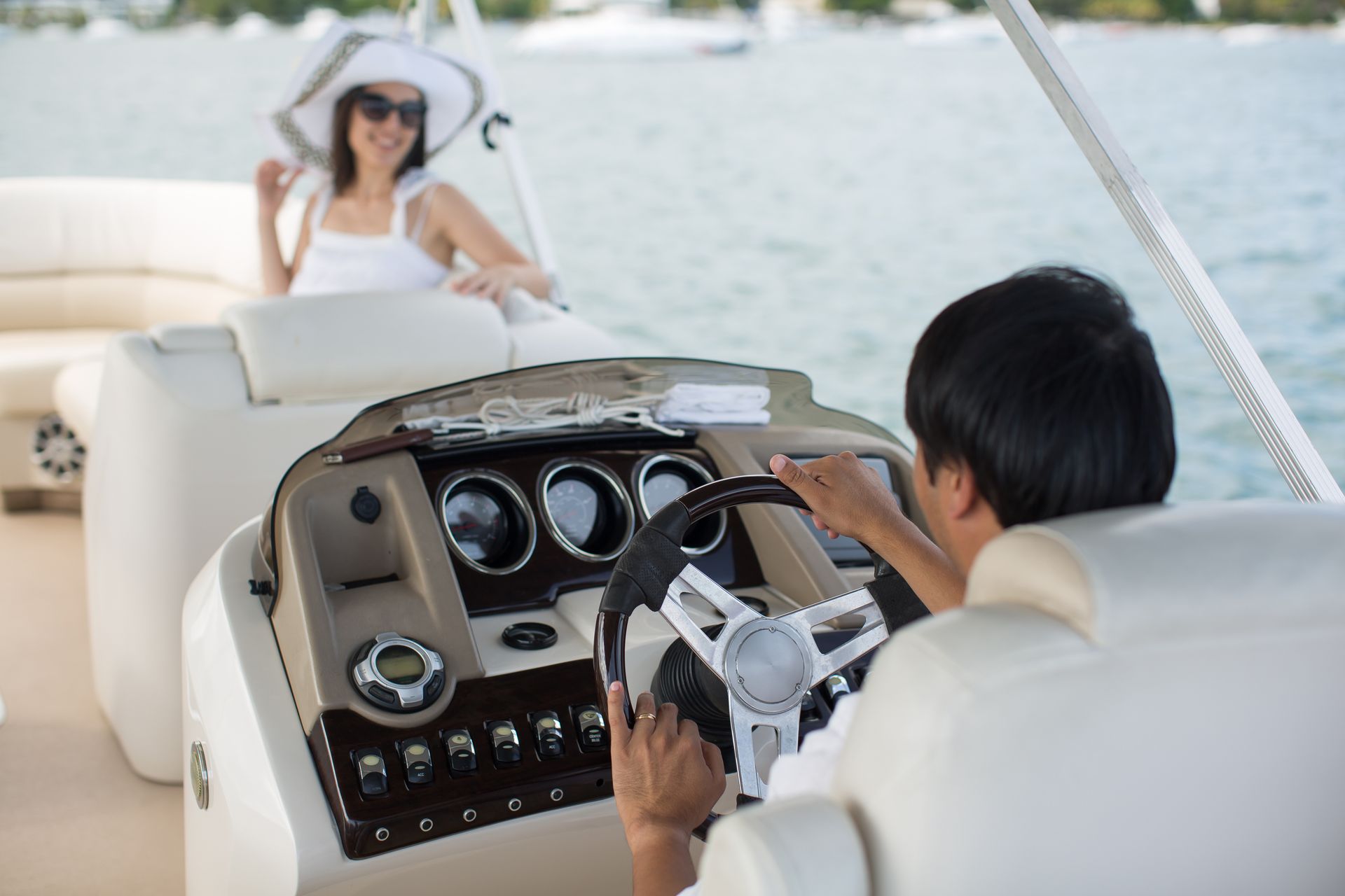 A man and a woman are sitting on a boat in the ocean.