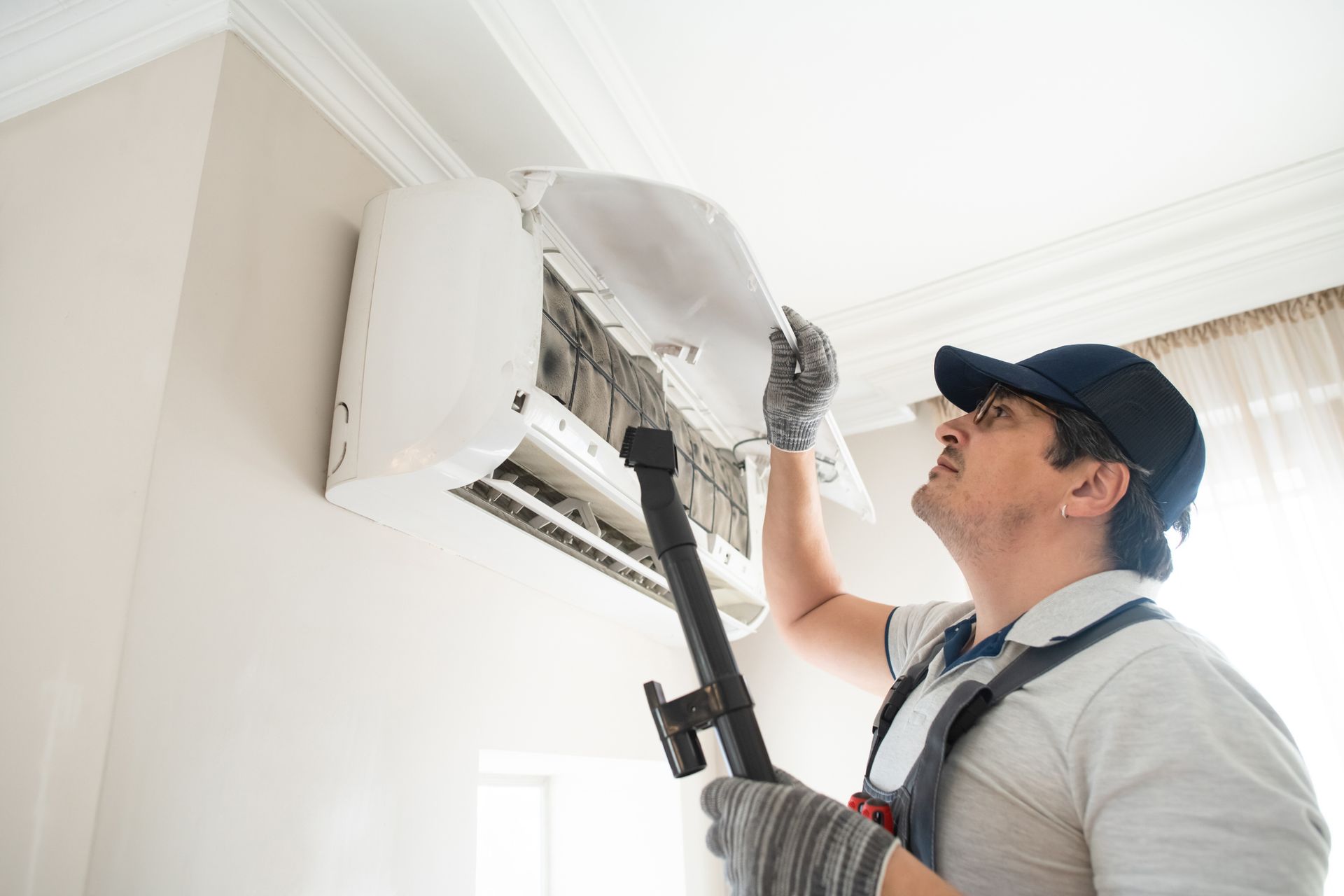 Assurance Aire technician performing an AC tune-up on a condenser at a Titusville, Florida home.