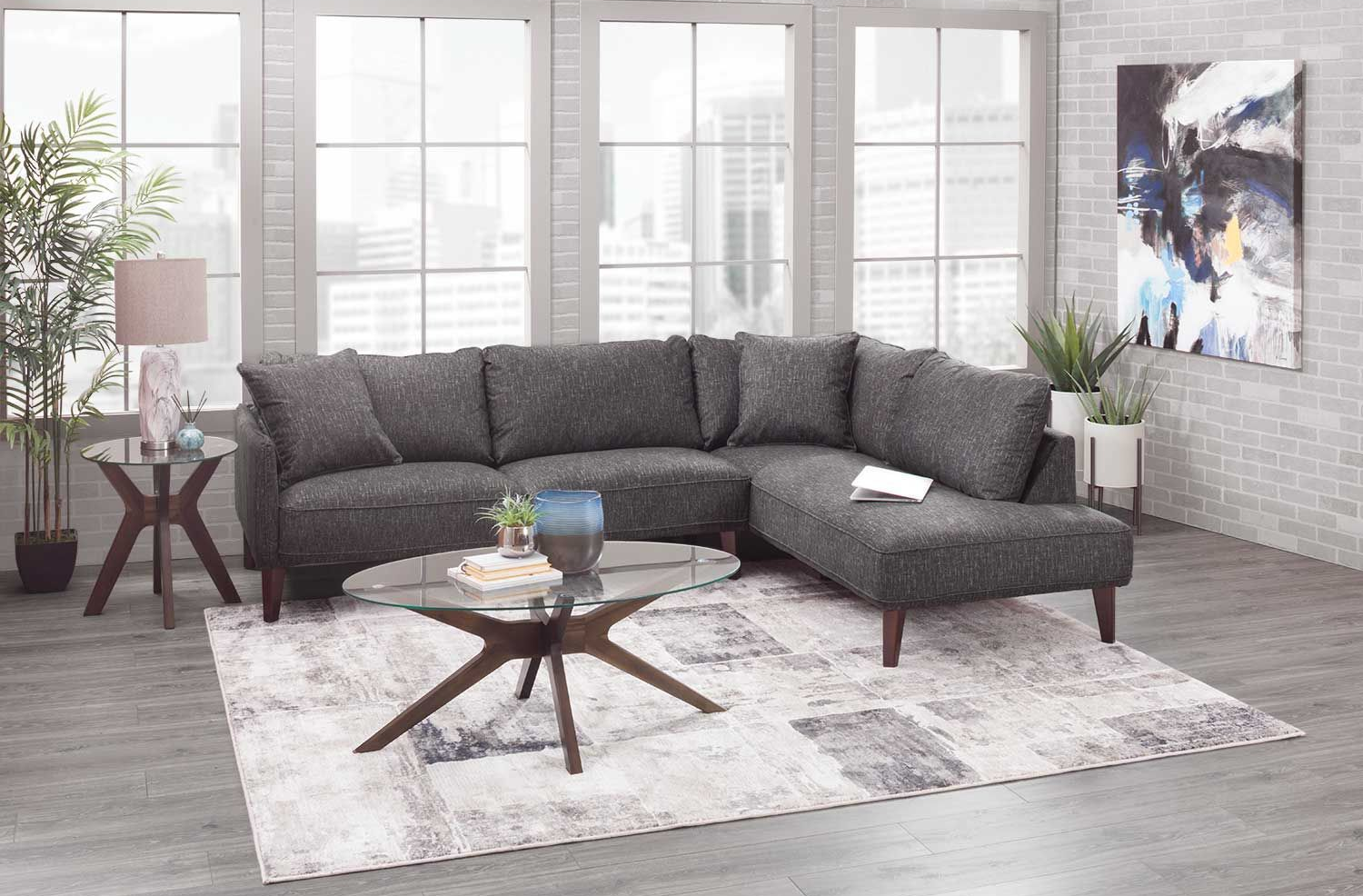 Gray sectional sofa in a modern living room setting with coffee table and rug.