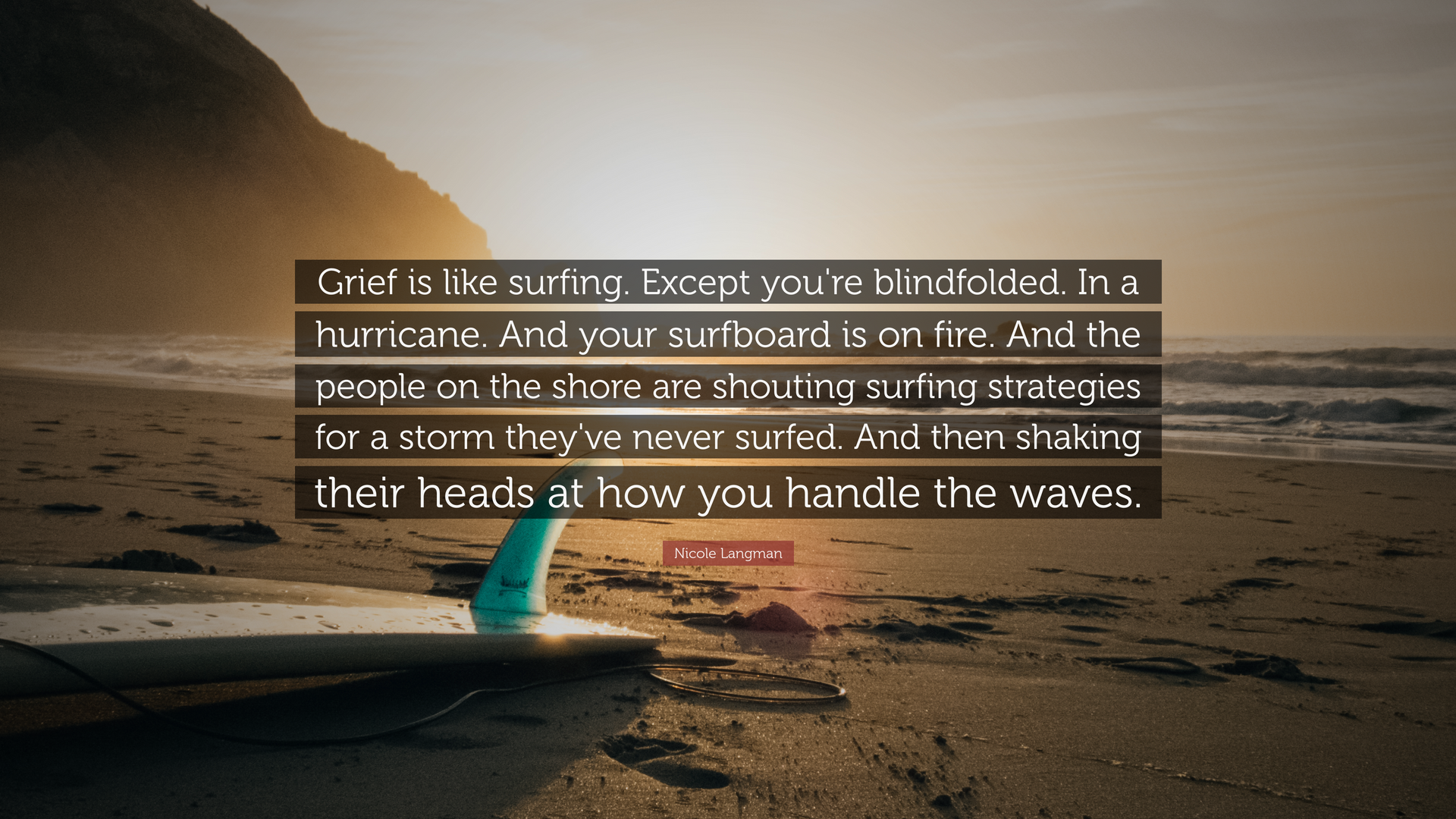 A surfboard is sitting on the beach with a quote on it.