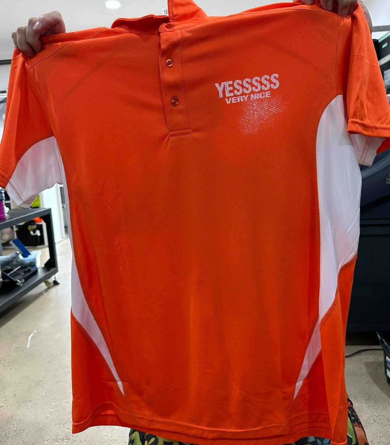 Orange polo shirt with white side panels and 