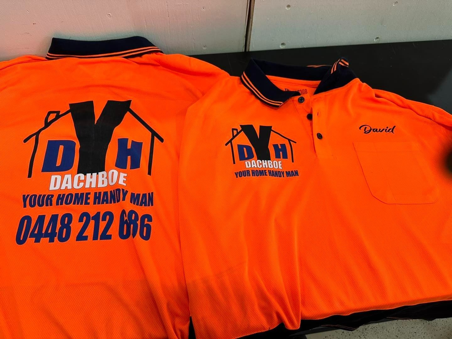 Two orange work shirts with business logo on back and front — That Printed Vinyl Place in Heatley, QLD
