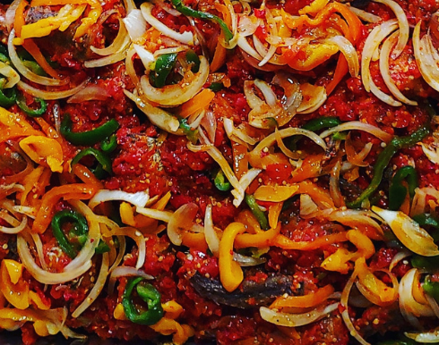A close up of a casserole dish filled with vegetables and meat