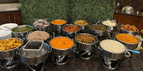 A buffet table filled with lots of different types of food.