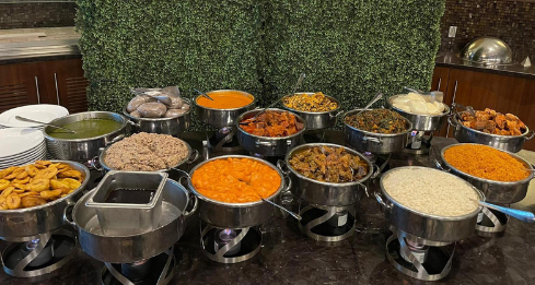 A buffet table filled with lots of different types of food.