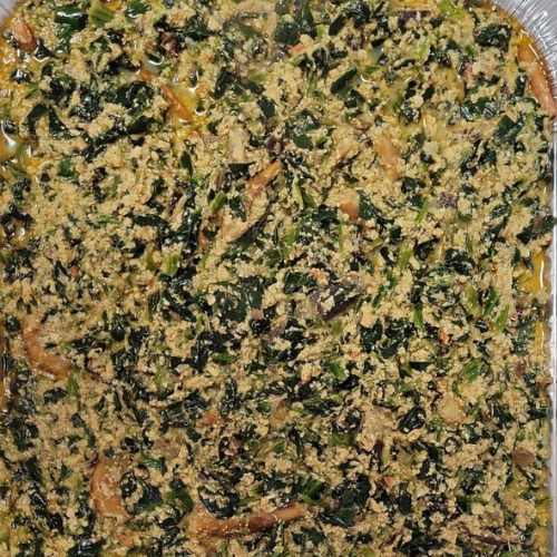 A close up of a casserole dish filled with rice and vegetables.