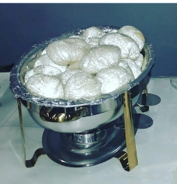Two bowls of food are sitting on a table.