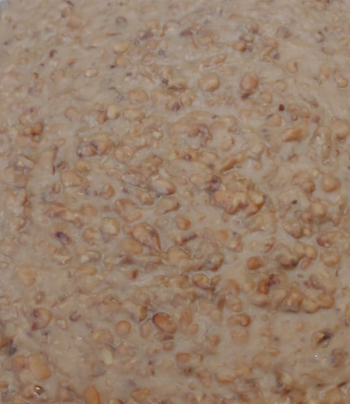 A tray of beans is sitting on a table.