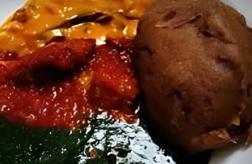 A bowl of food with tomato sauce and green sauce