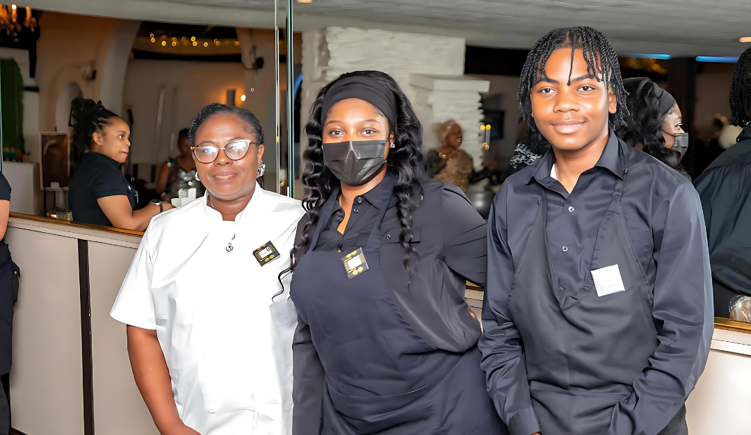 A group of people wearing masks are posing for a picture.