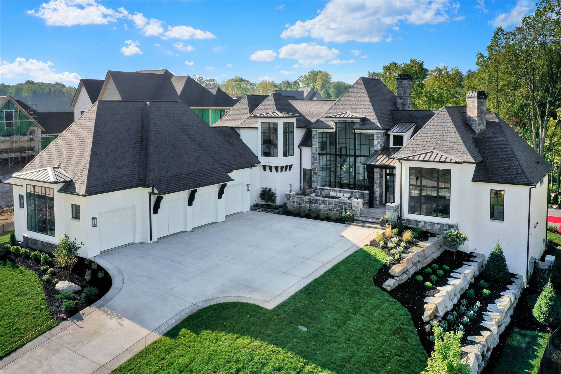 An Aerial View Of A Large White House With A Black Roof - Carmel, IN - Goldberg Design Group