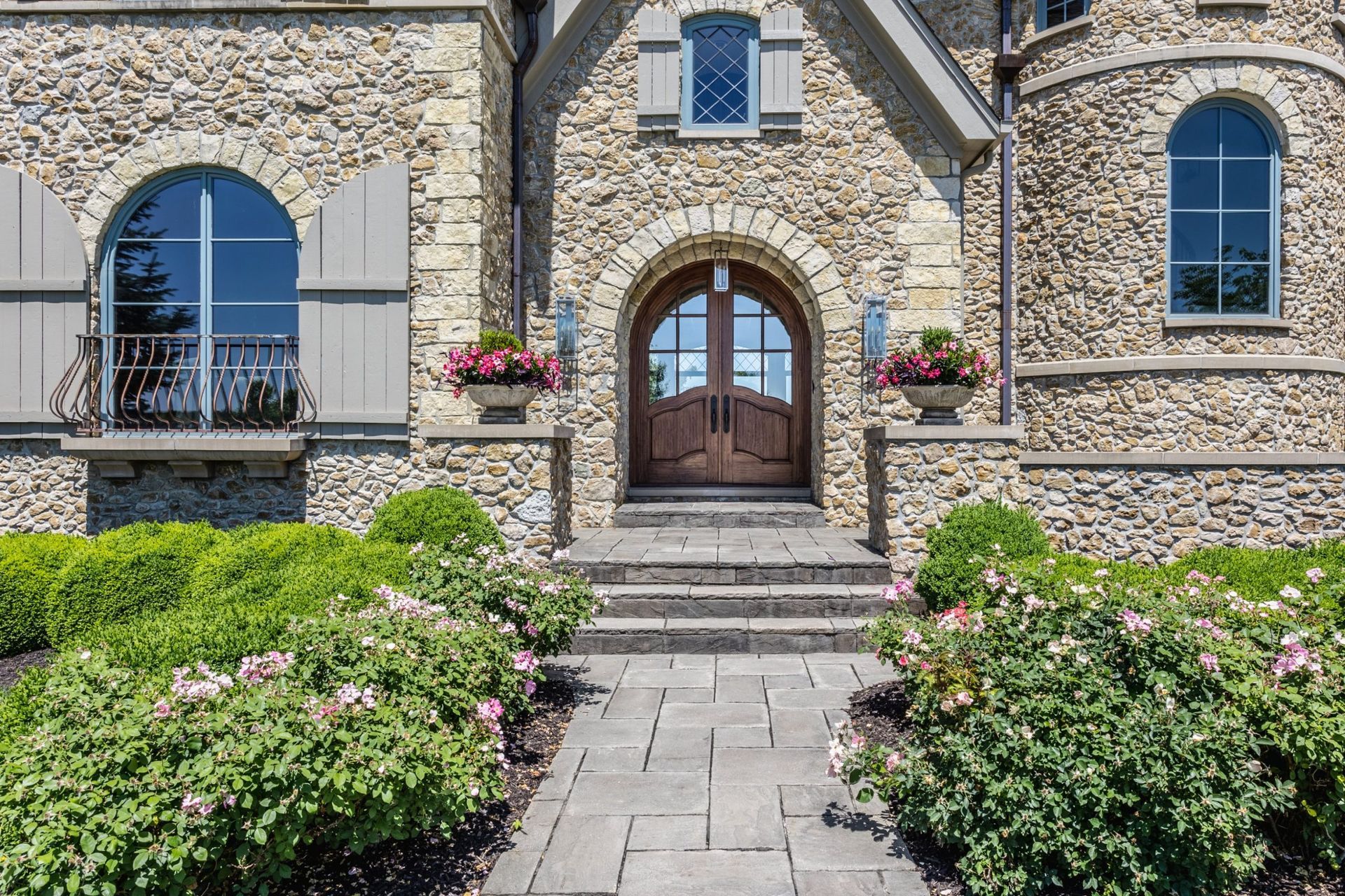 A Large Stone House With Arched Windows - Carmel, IN - Goldberg Design Group