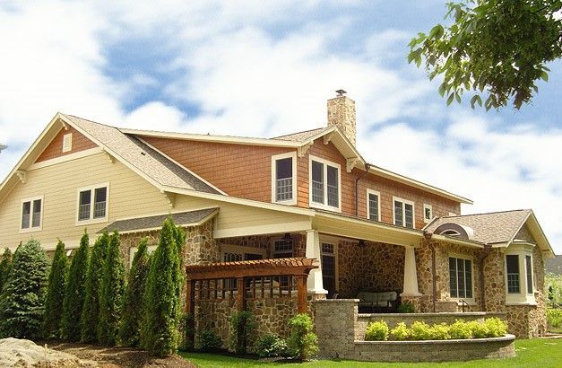 A Large House With A Porch And Trees In Front Of It - Carmel, IN - Goldberg Design Group