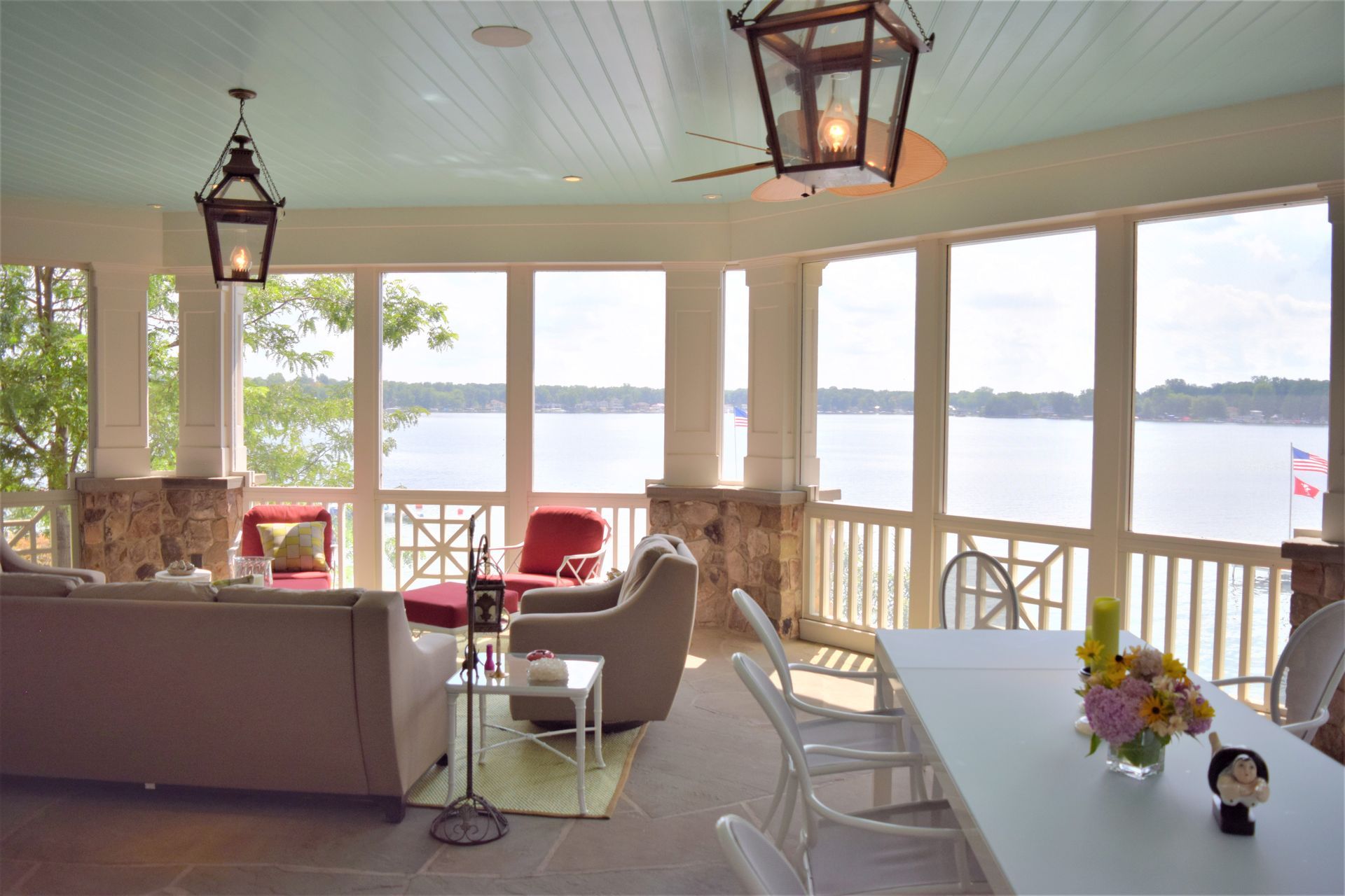 a screened in porch with a view of a lake