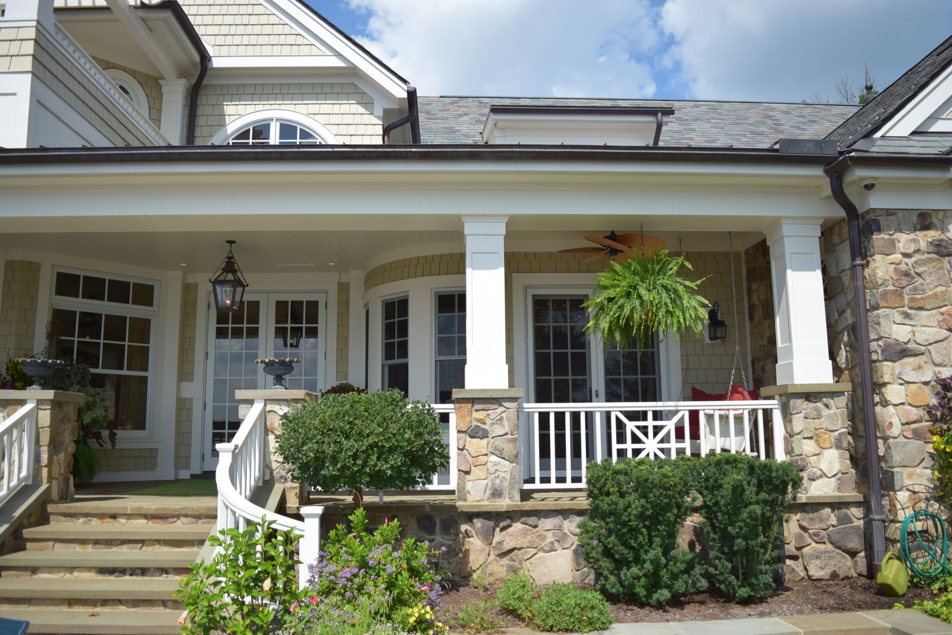 A Large House With A Large Porch And Stairs - Carmel, IN - Goldberg Design Group
