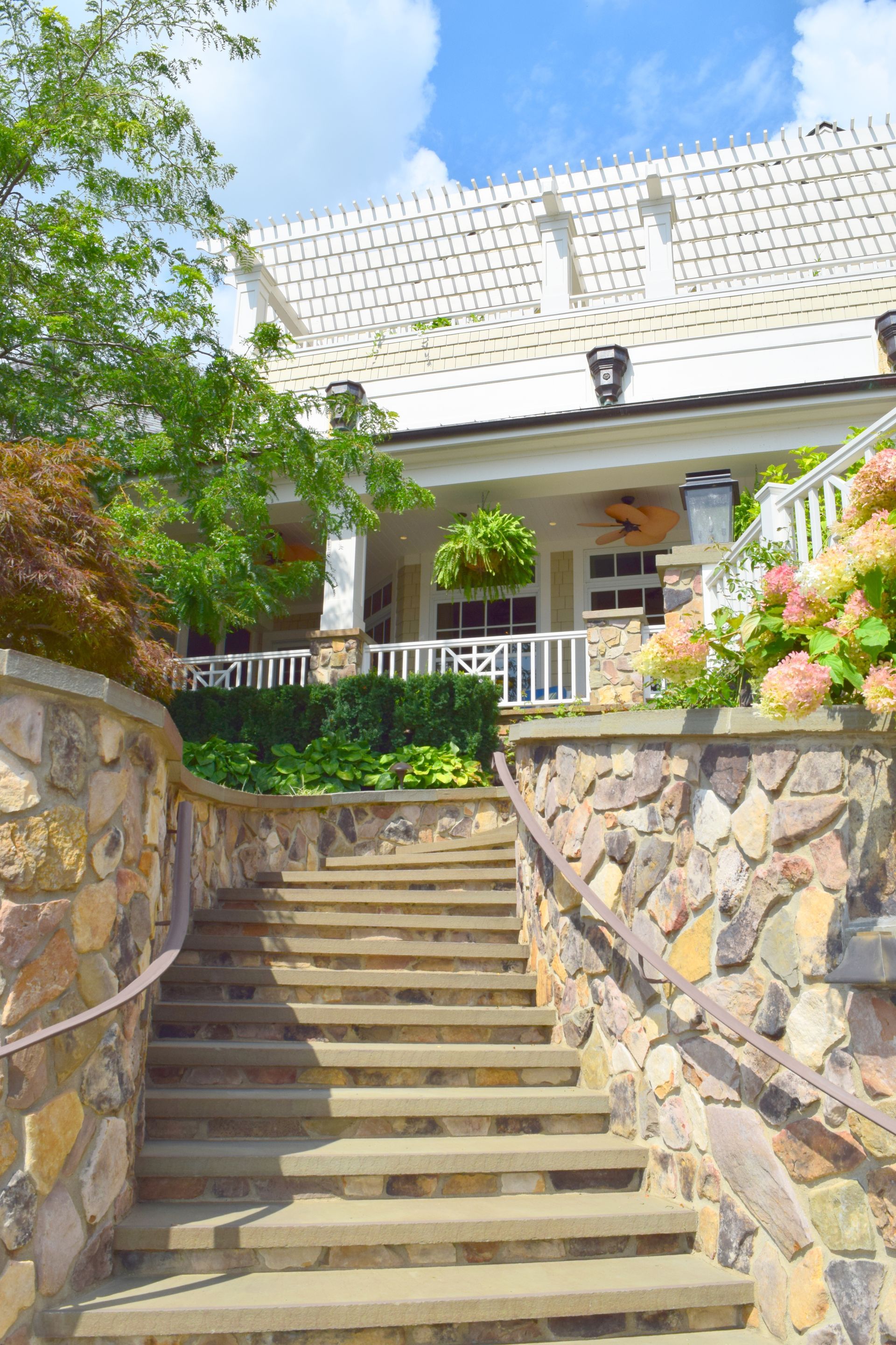 a stone wall with stairs leading up to a house .