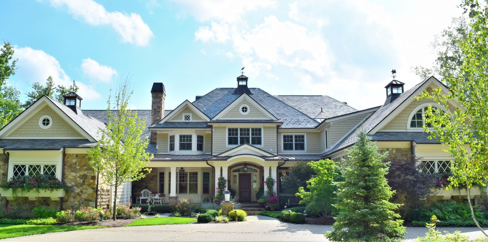 a large house with a lot of windows and trees in front of it
