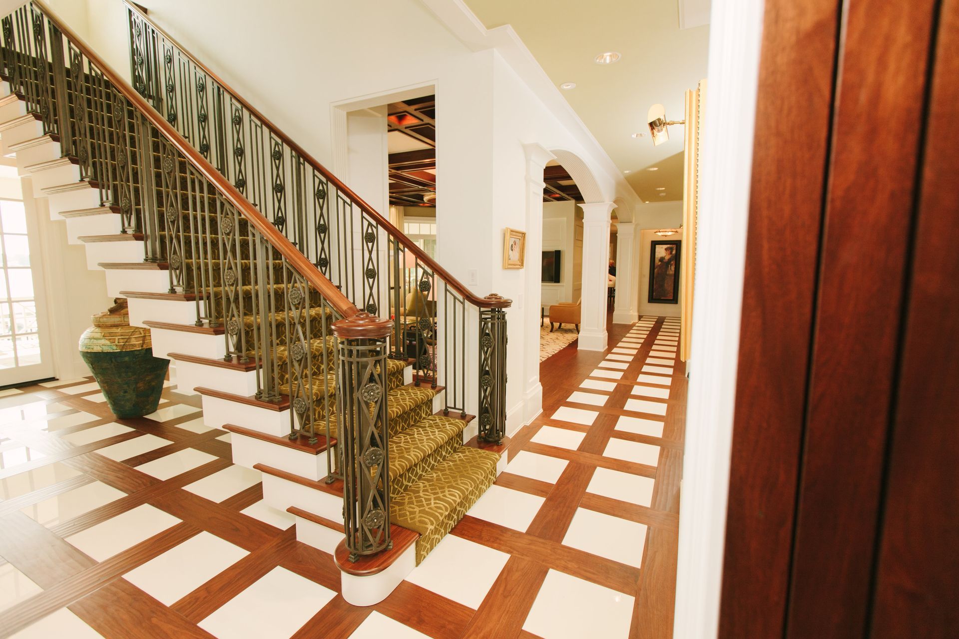 A Hallway With A Staircase Leading Up To The Second Floor - Carmel, IN - Goldberg Design Group