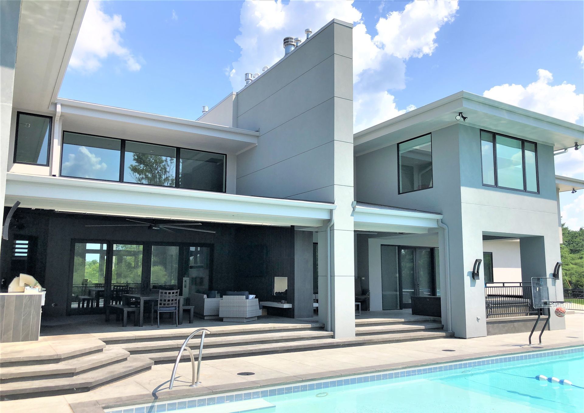 A Large House With A Swimming Pool In Front Of It - Carmel, IN - Goldberg Design Group