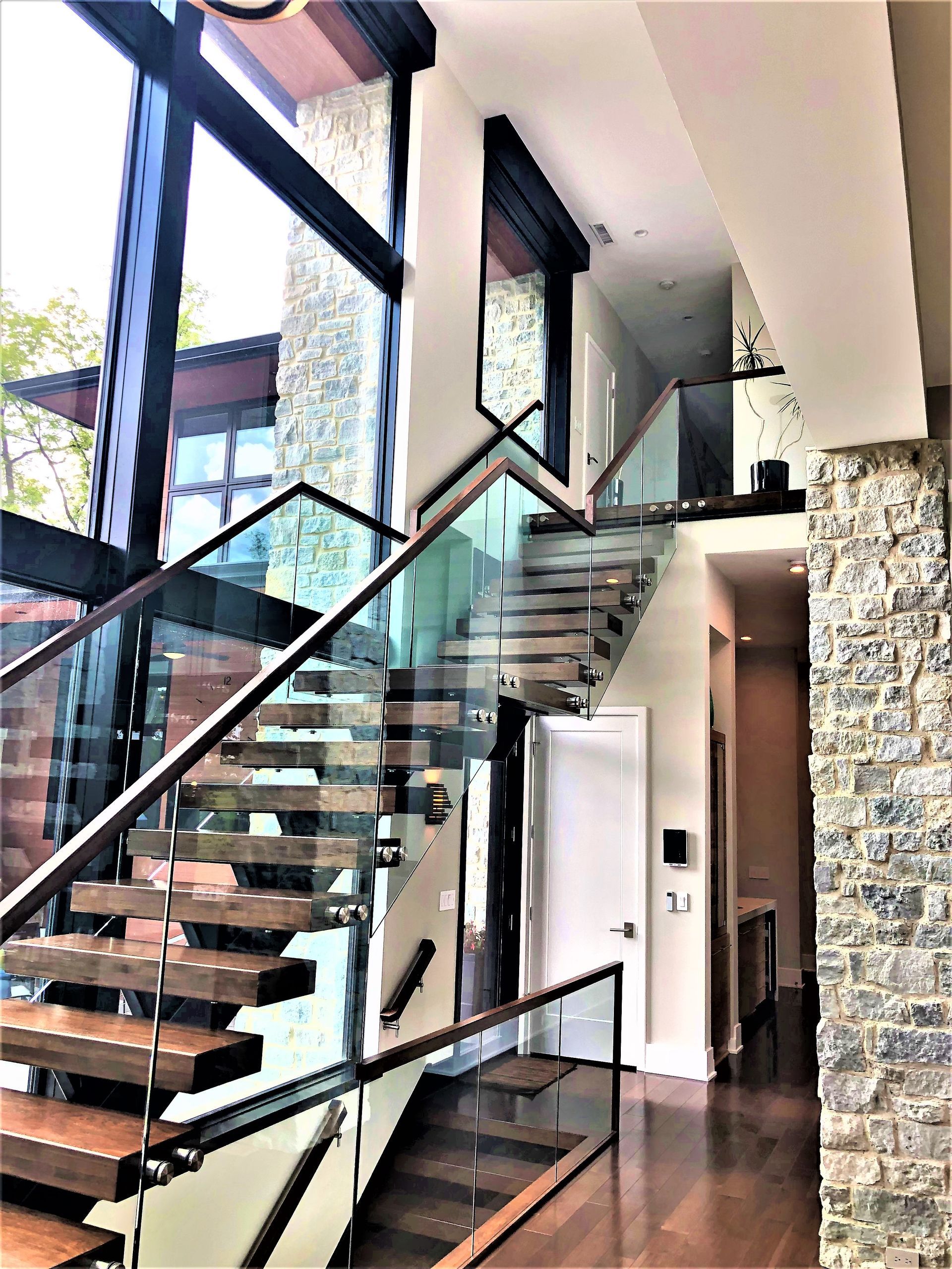 A Modern Staircase With A Glass Railing - Carmel, IN - Goldberg Design Group