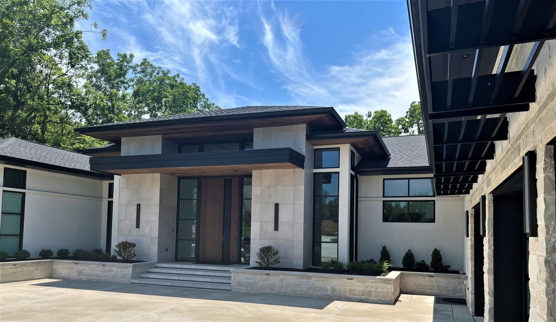 A Modern House With A Lot Of Windows And A Large Driveway - Carmel, IN - Goldberg Design Group