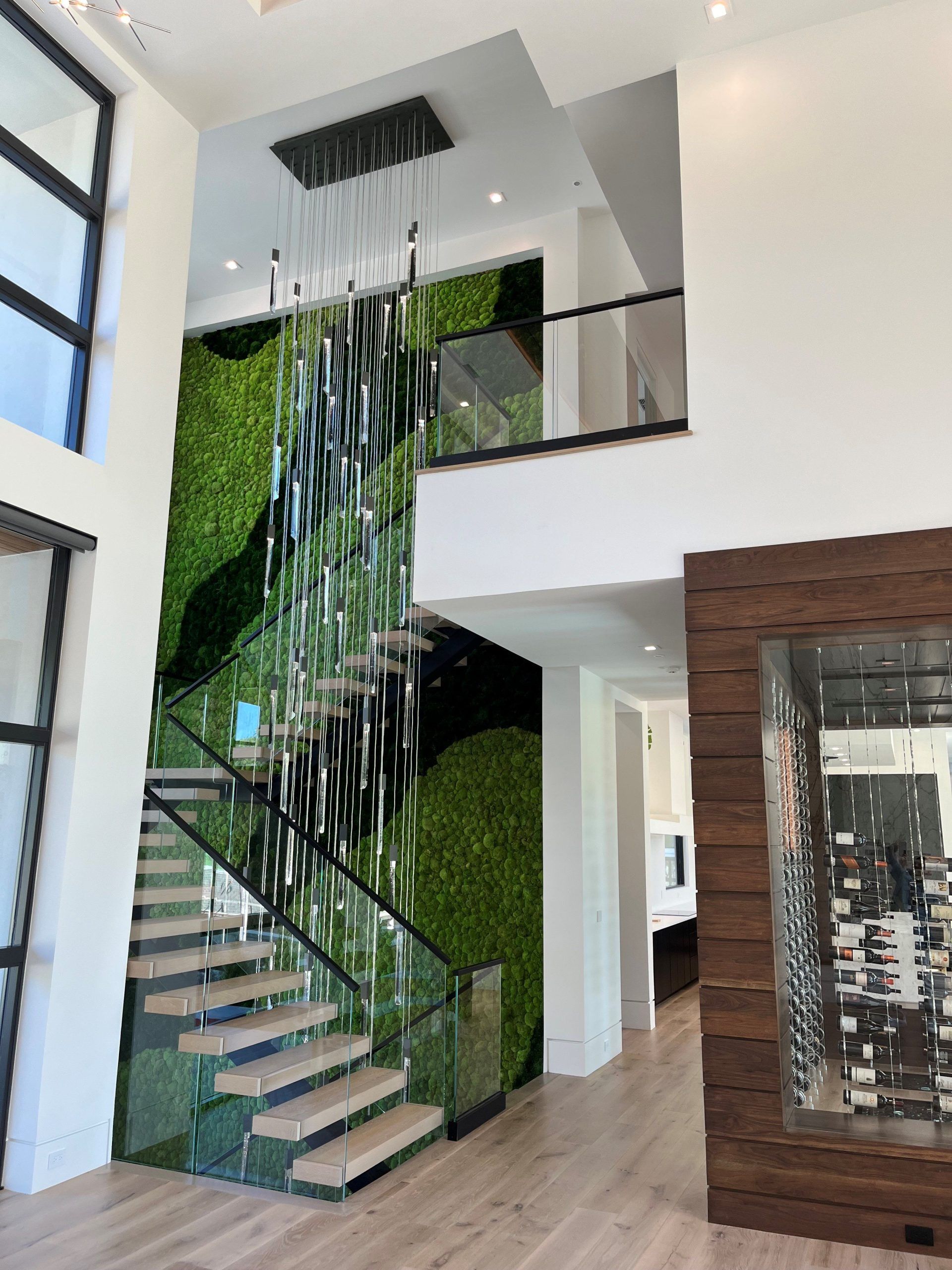 A Staircase In A House With A Green Wall Behind It - Carmel, IN - Goldberg Design Group