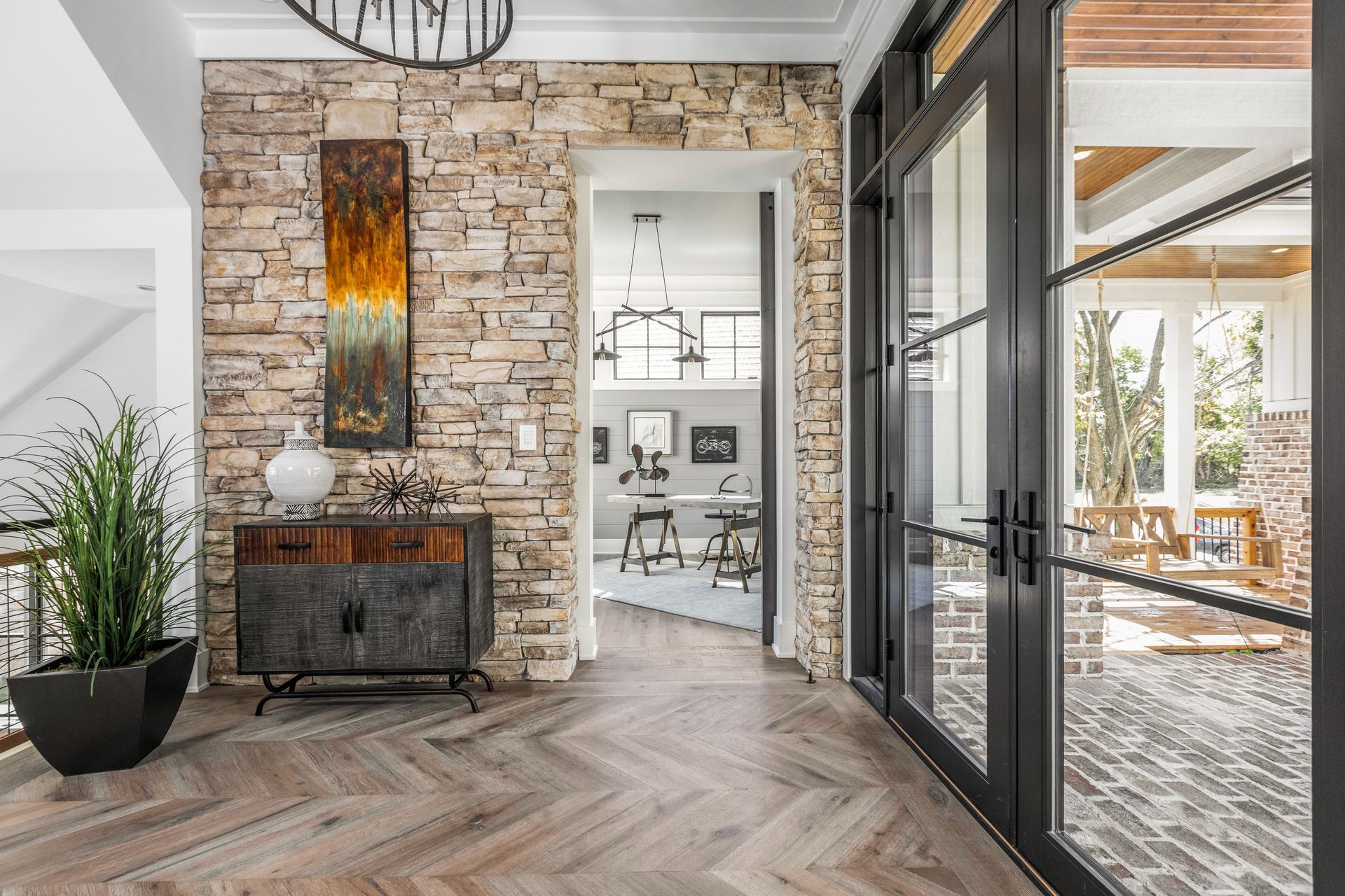 A Hallway In A House With A Brick Wall - Carmel, IN - Goldberg Design Group