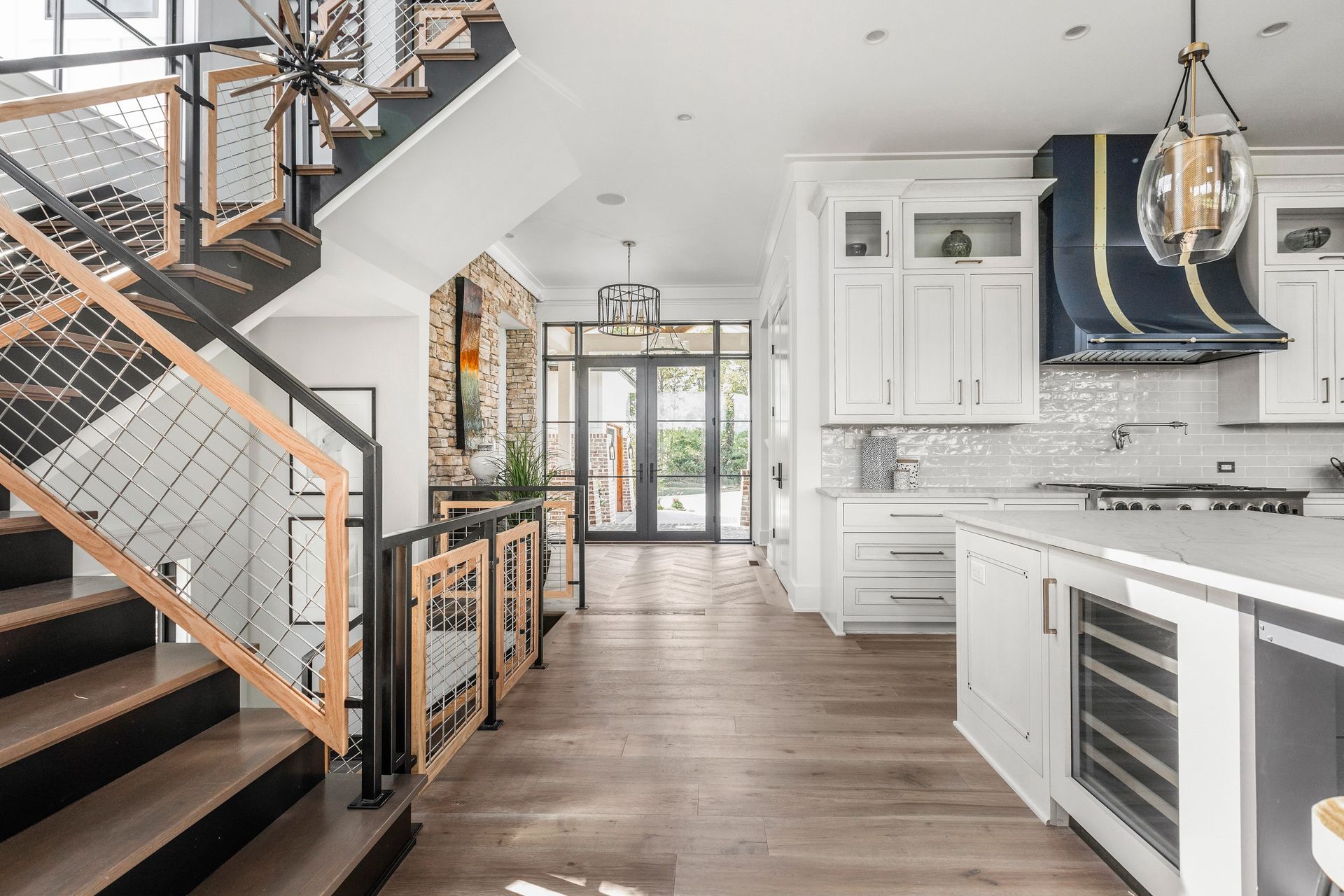 A Kitchen With A Staircase Leading Up To The Second Floor - Carmel, IN - Goldberg Design Group