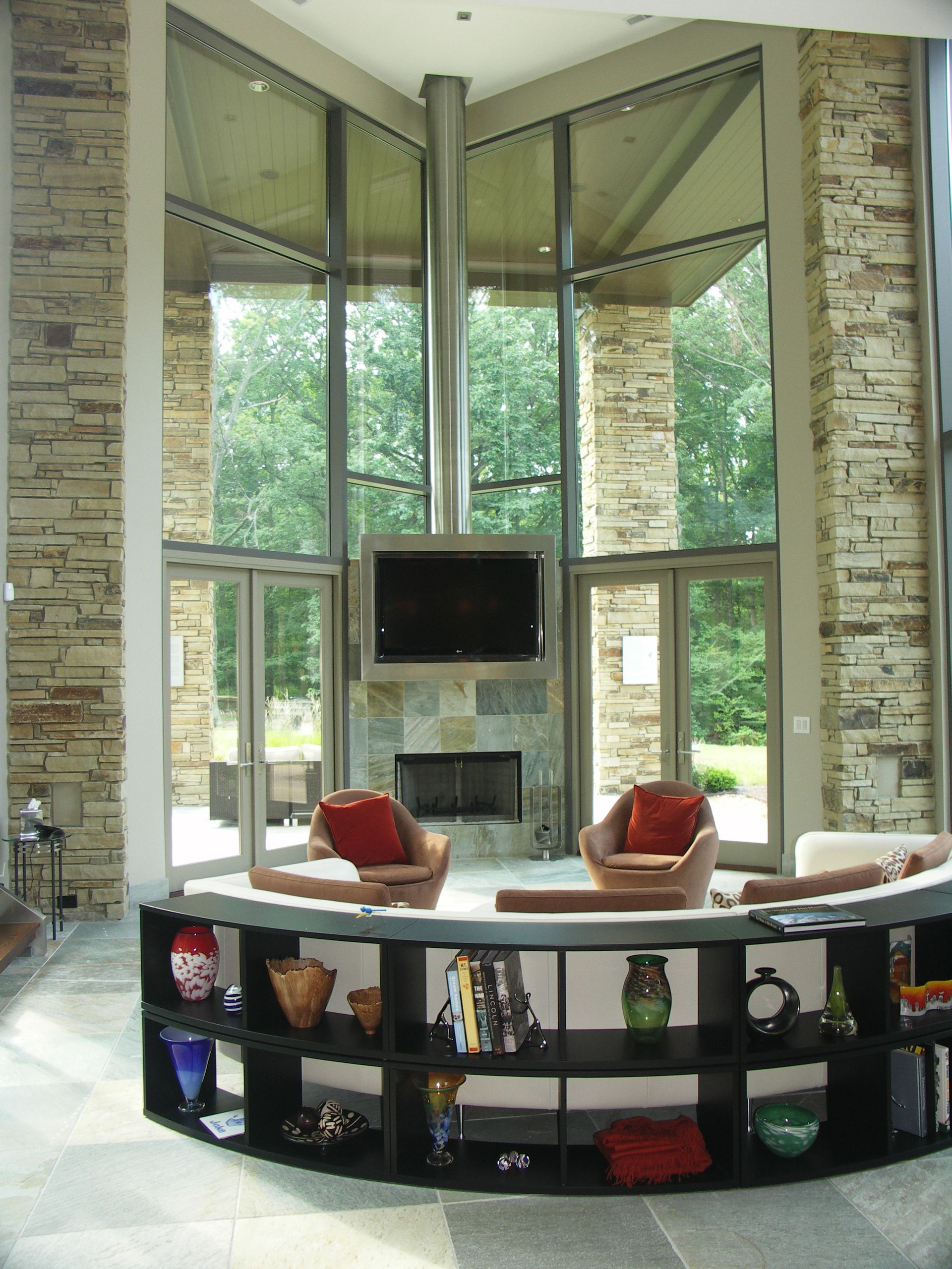 A Living Room With A Fireplace And A Flat Screen Tv - Carmel, IN - Goldberg Design Group