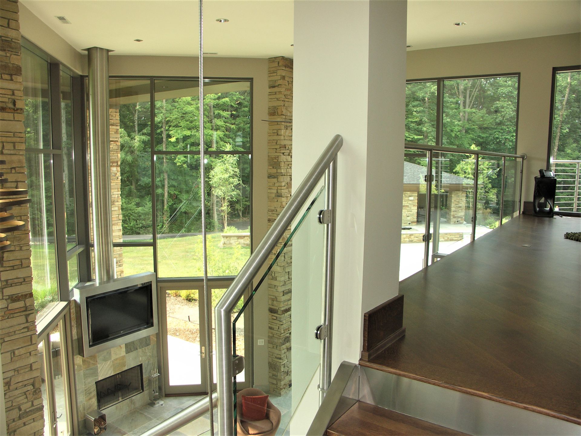 A Living Room With A Fireplace And Stairs Leading Up To It - Carmel, IN - Goldberg Design Group
