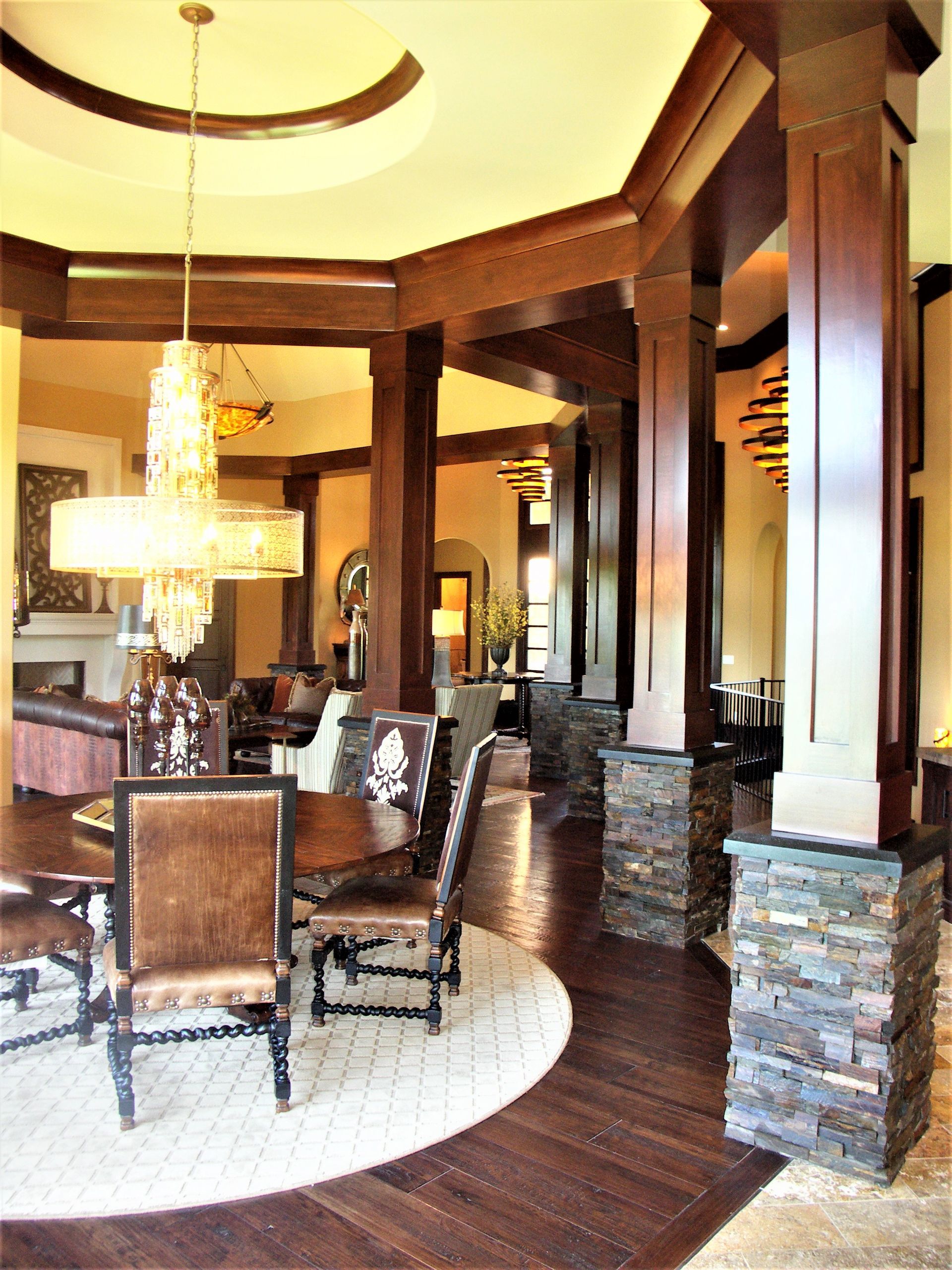 A Dining Room With A Table And Chairs And A Chandelier Hanging From The Ceiling - Carmel, IN - Goldberg Design Group